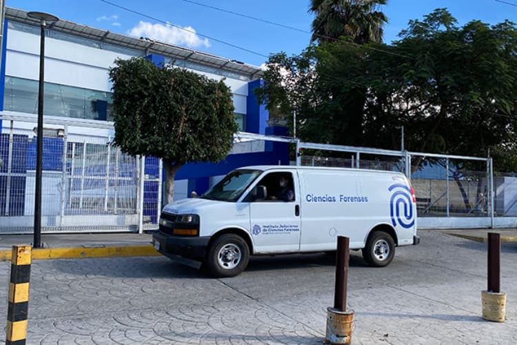 Furgón de Ciencias Forenses frente a un edificio, utilizado para la identificación de personas en Jalisco, destacando la